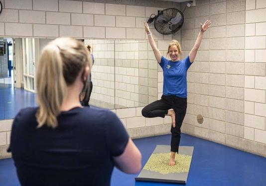 Employee health coach Lindsay Bloom leads a yoga class